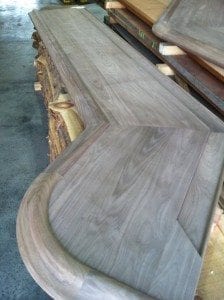 Custom walnut bar top with our curved Chicago Style bar rail molding.
