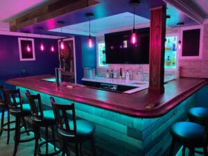 Nice L Shaped Home Bar with Oak Chicgao Bar Rails.