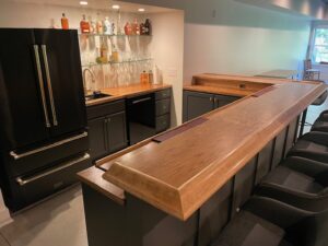Bar area with BR475 Birch Bar Rail Molding by Hardwoods Incorporated.